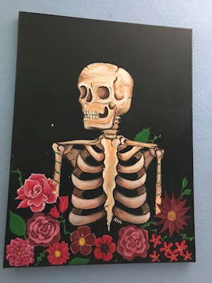 A skeleton and red flowers